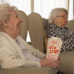 Two women watching a film